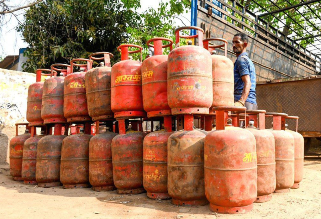 Stacks of LPG gas cylinders at a local distribution point, highlighting the importance of a stable supply chain for household cooking fuel.